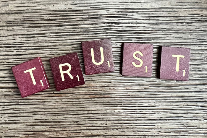 Photo Scrabble Tiles spelling out the word "trust"